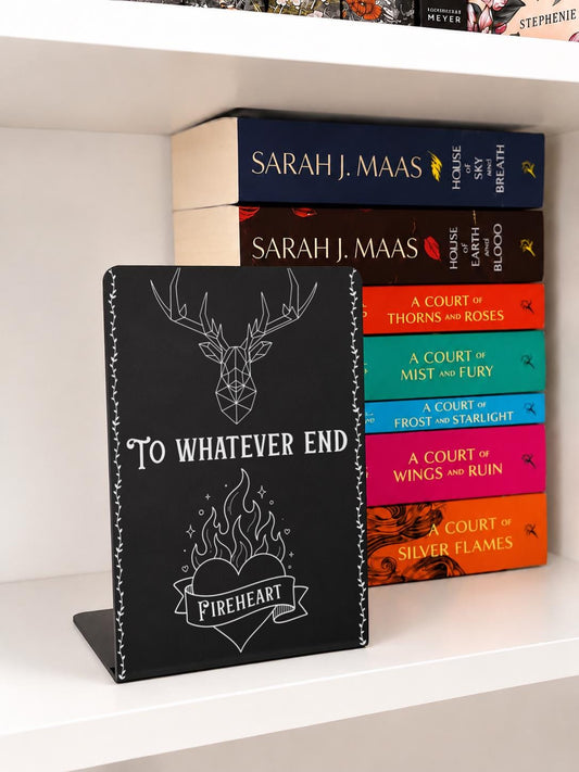 To Whatever End Metal Bookshelf Bookends featuring a geometric stag and flaming heart design displayed with fantasy books