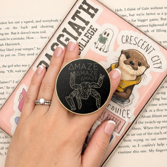 Sci-Fi Amaze Metal MagSafe Kindle Grip held in hand while reading an e-reader
