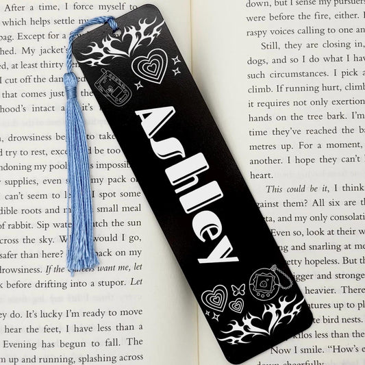 Personalised Name Retro Vibe Metal Bookmark in black featuring a custom name, retro hearts, flames and nostalgic icons with a blue tassel.