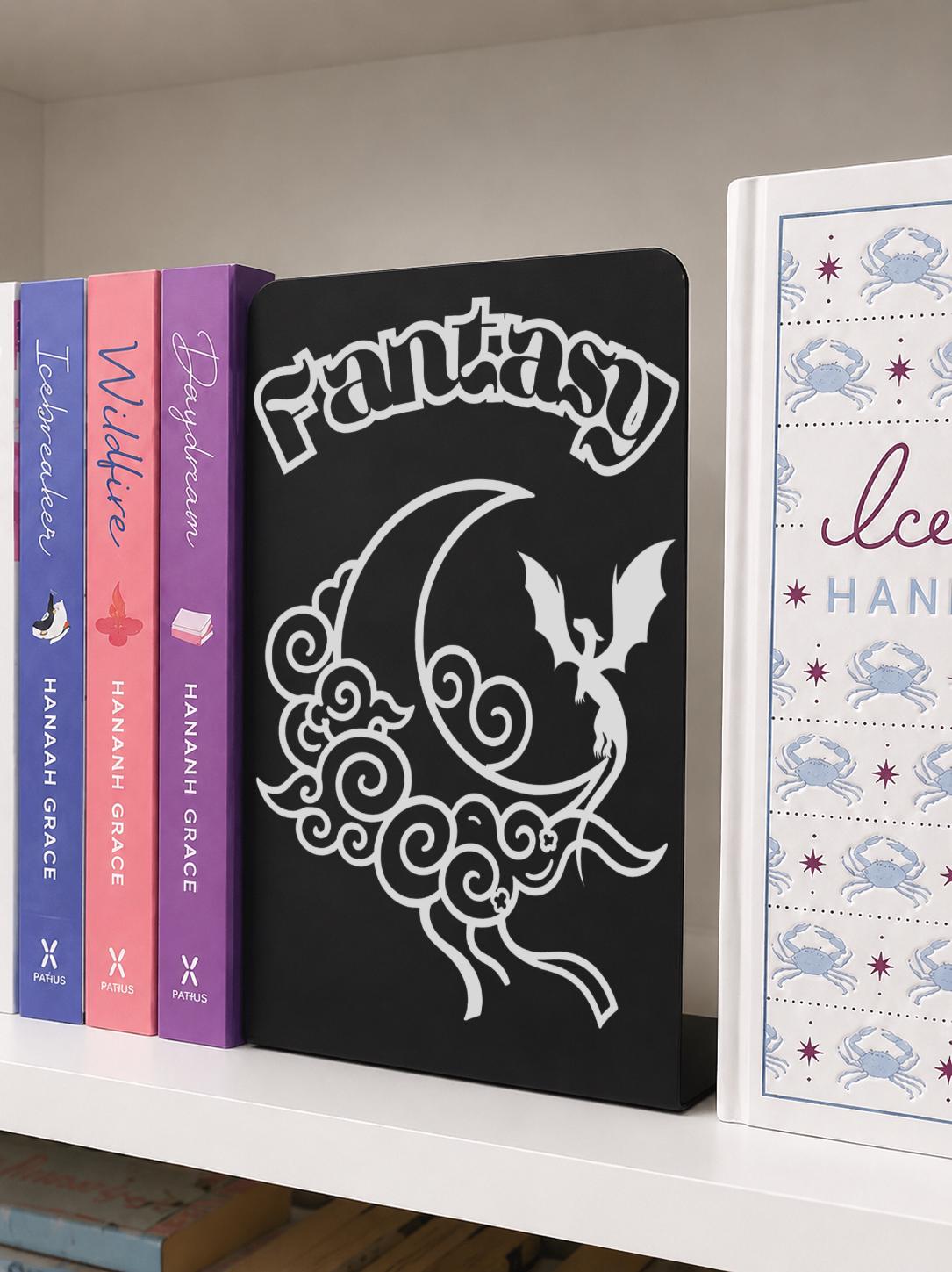 Fantasy Genre Metal Bookshelf Sign Bookend with dragon, moon and cloud design beside colourful romance and fantasy novels