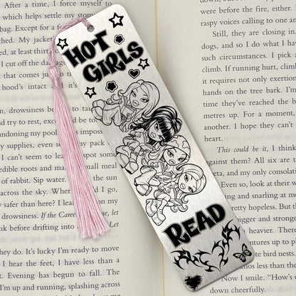 A brushed silver Y2K Hot Girls Read Metal Bookmark on an open book with a pink tassel