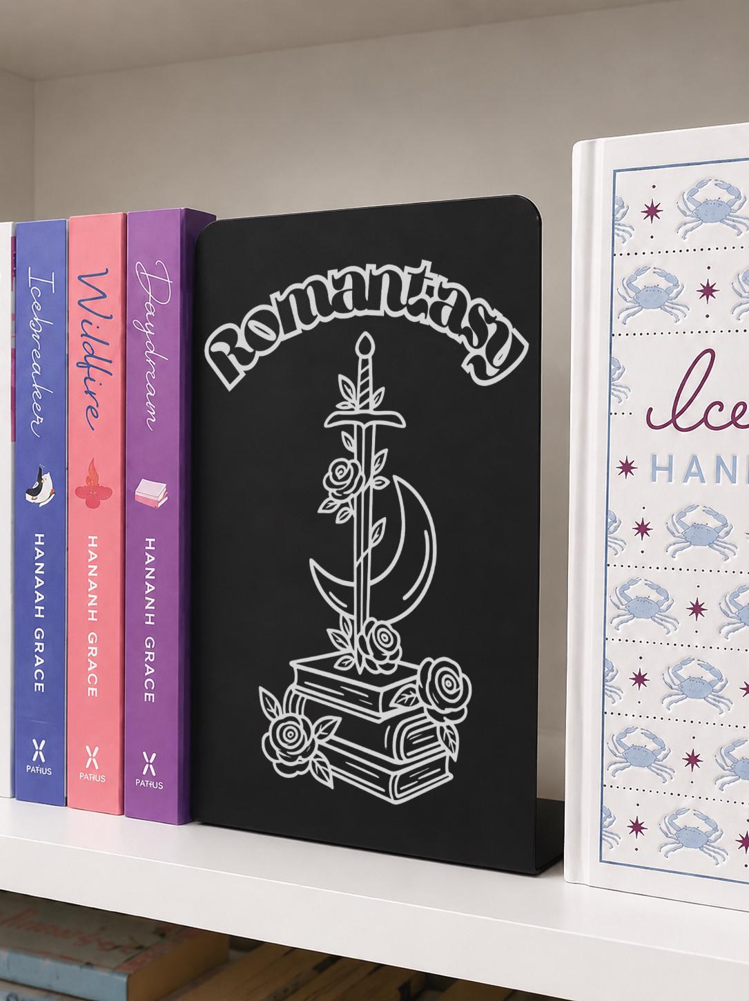     Romantasy Genre Metal Bookshelf Sign Bookend displayed on a bookshelf beside colourful romance and fantasy novels.