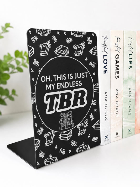     Endless TBR Quote Bookshelf Sign Bookends in black laser engraved metal with book stack illustrations, shown supporting books on a shelf.