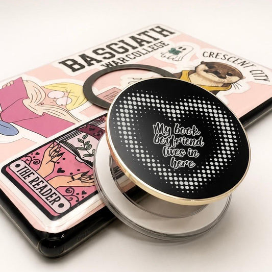     Close-up of Book Boyfriend Metal Kindle Grip with black and white bookish heart design