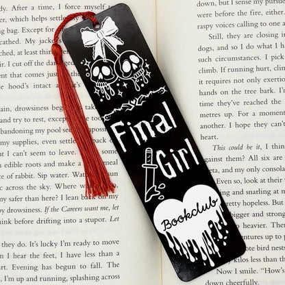     Black Final Girl Slasher Genre Metal Bookmark with red tassel displayed inside an open book.