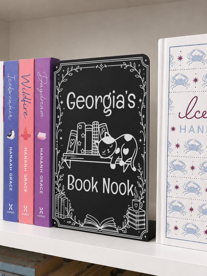     Personalised Name Metal Bookshelf Sign Bookends featuring “Georgia’s Book Nook” with an engraved sleeping cat, books and decorative botanical border.