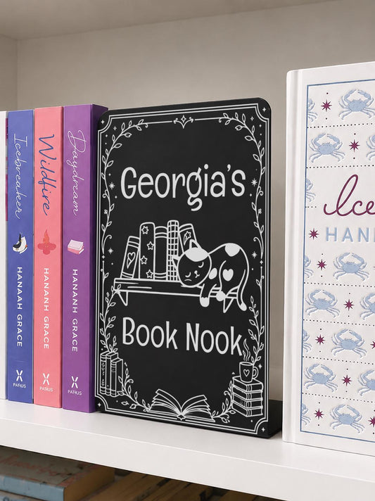    Personalised Name Metal Bookshelf Sign Bookends featuring “Georgia’s Book Nook” with an engraved sleeping cat, books and decorative botanical border.