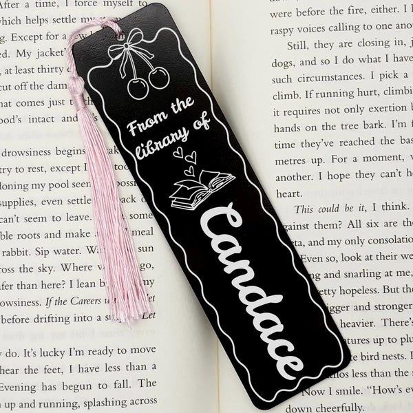     Black Personalised Name Cherries Metal Bookmark displayed on an open book with custom name engraving