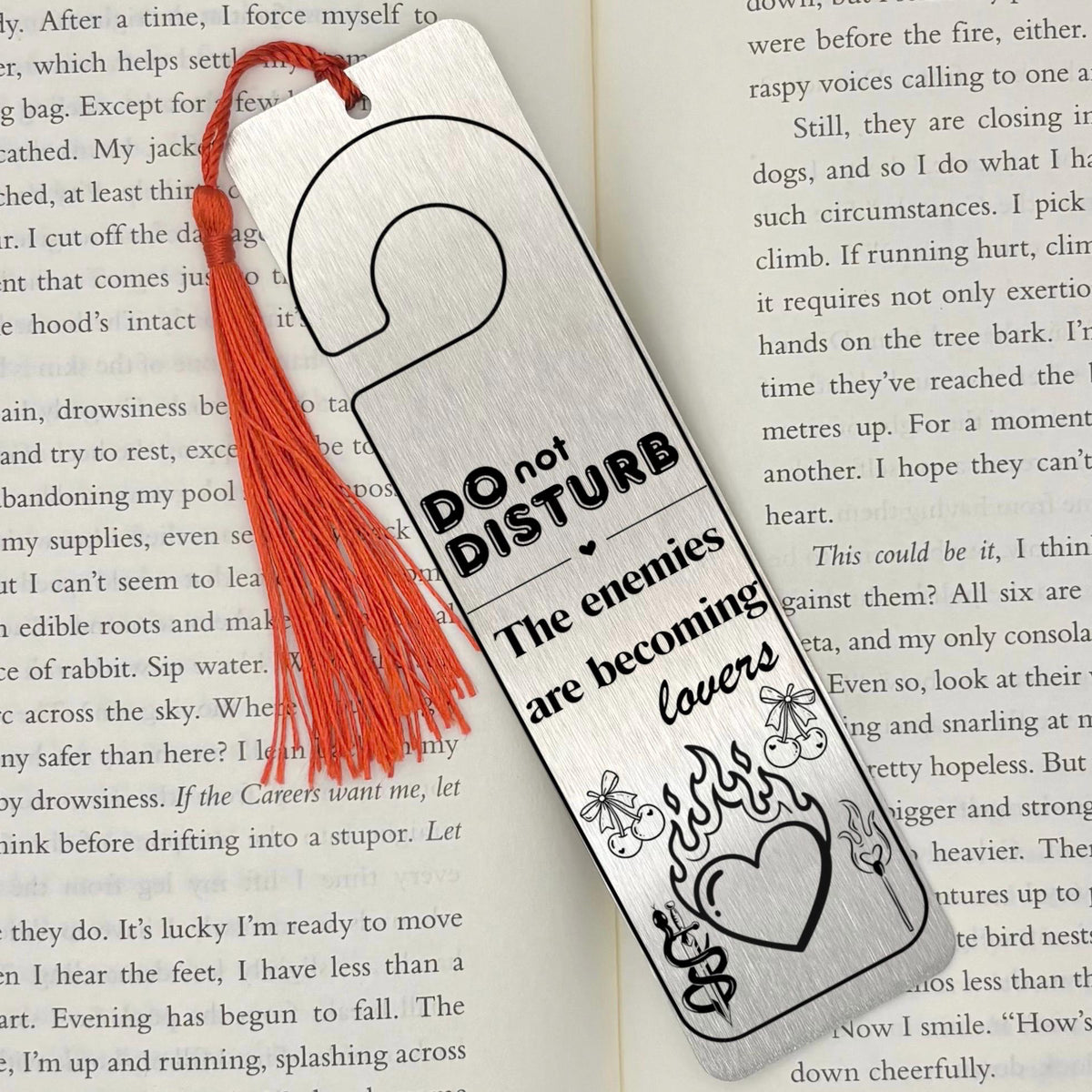     Enemies to Lovers Dark Romance Bookmark in brushed silver metal with engraved romance design and red tassel