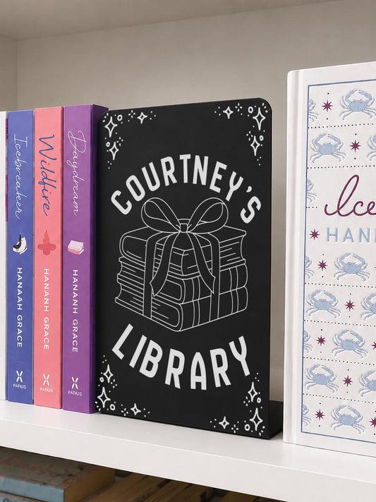     Custom Name Library Metal Bookshelf Sign Bookends in black metal with custom library name and book stack design on a bookshelf