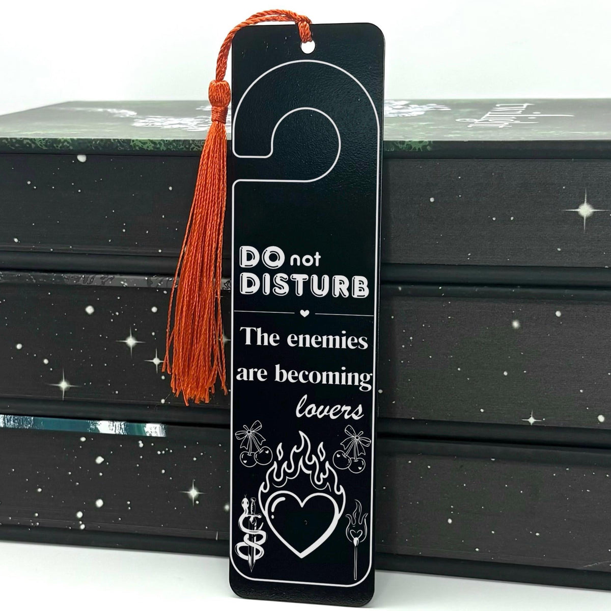     Black Enemies to Lovers Dark Romance Bookmark displayed inside an open book with flaming heart and cherry details