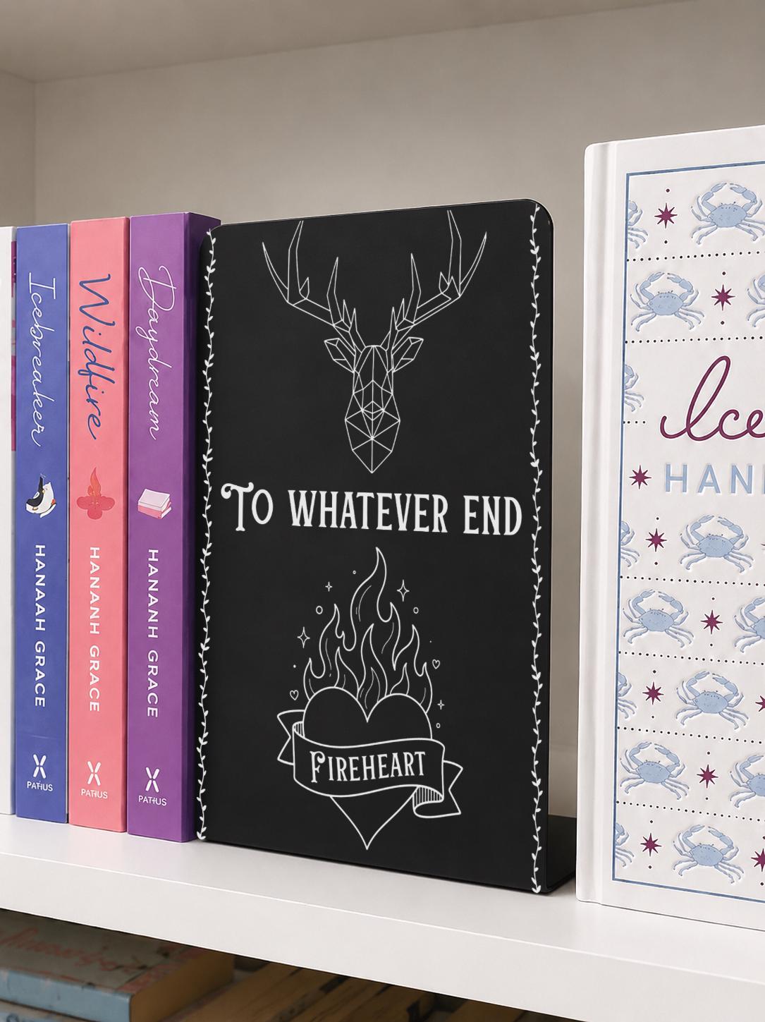     To Whatever End Metal Bookshelf Bookends featuring a stag and flaming Fireheart design displayed between books on a shelf