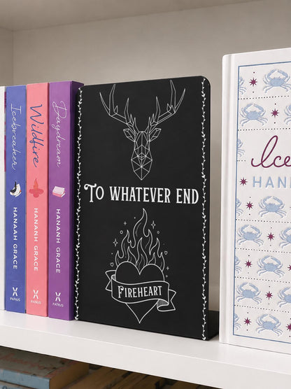     To Whatever End Metal Bookshelf Bookends featuring a stag and flaming Fireheart design displayed between books on a shelf