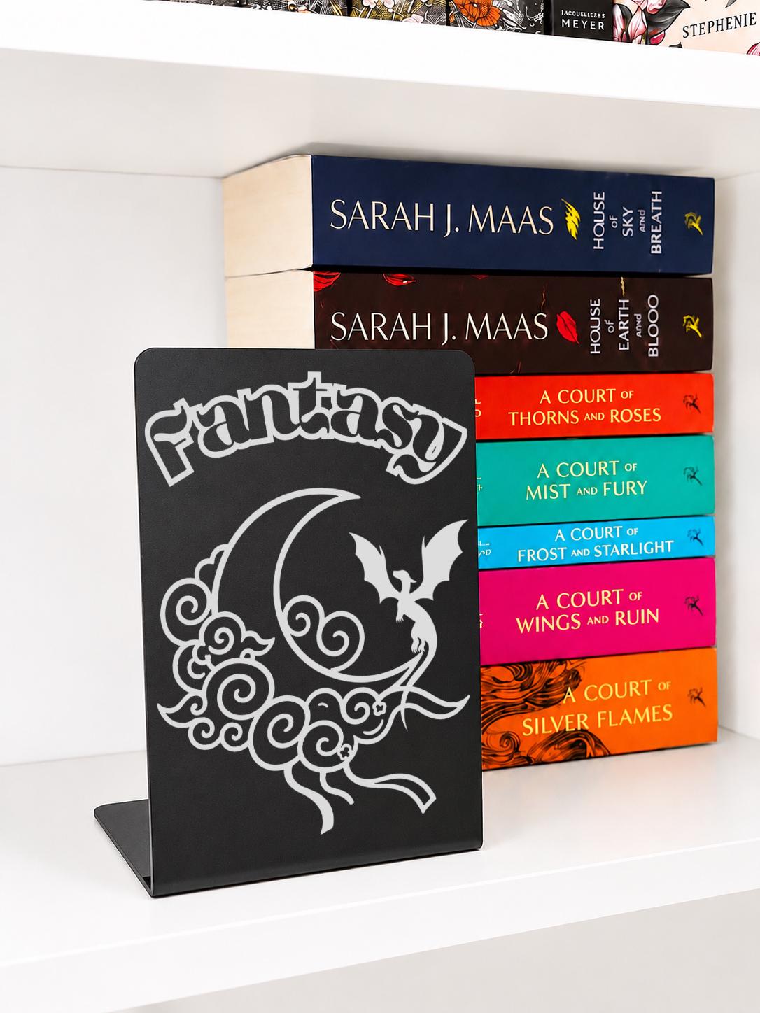     Fantasy Genre Metal Bookshelf Sign Bookend featuring engraved dragon and crescent moon design displayed with fantasy books