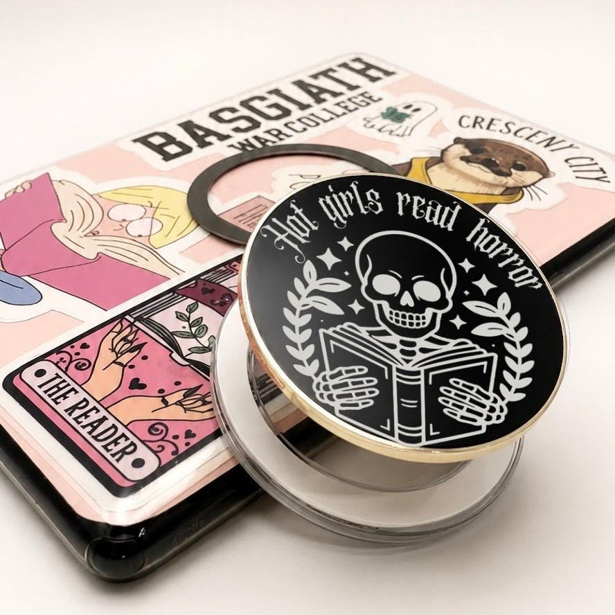     Hot Girls Read Horror Metal Kindle MagSafe Grip featuring engraved skeleton reading design and gothic bookish style
