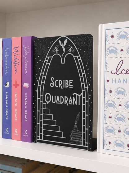     Scribe Quadrant Metal Bookshelf Bookends displayed with fantasy and romance books on a bookshelf