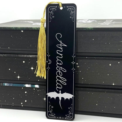     Personalised Name Dragon Bookmark in black metal featuring the name Annabella, engraved dragon design, celestial details and gold tassel.