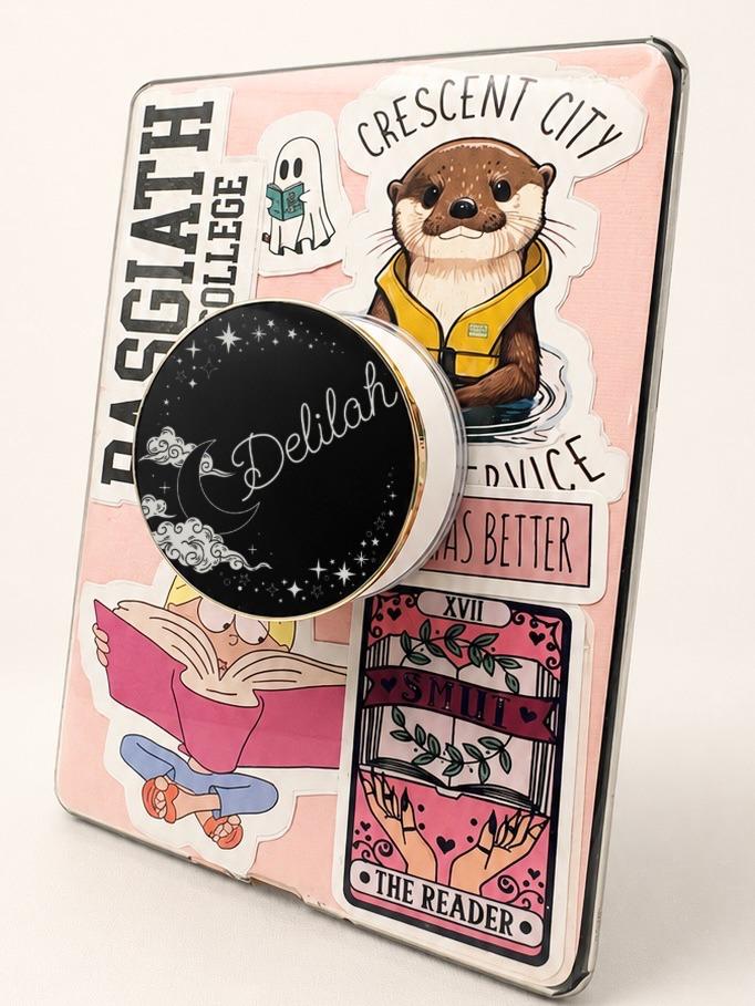     Personalised Name Celestial Metal Kindle Grip with crescent moon, clouds and stars displayed on an e-reader