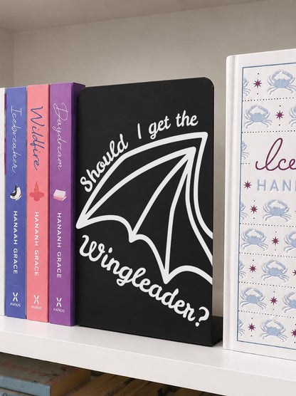     Should I Get The Wingleader Metal Bookshelf Sign Bookends displayed on a bookshelf beside colourful romance books.