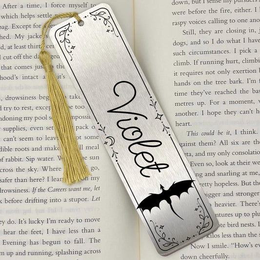     Personalised Name Dragon Bookmark in brushed silver metal with custom name, engraved dragon and decorative celestial border on an open book.