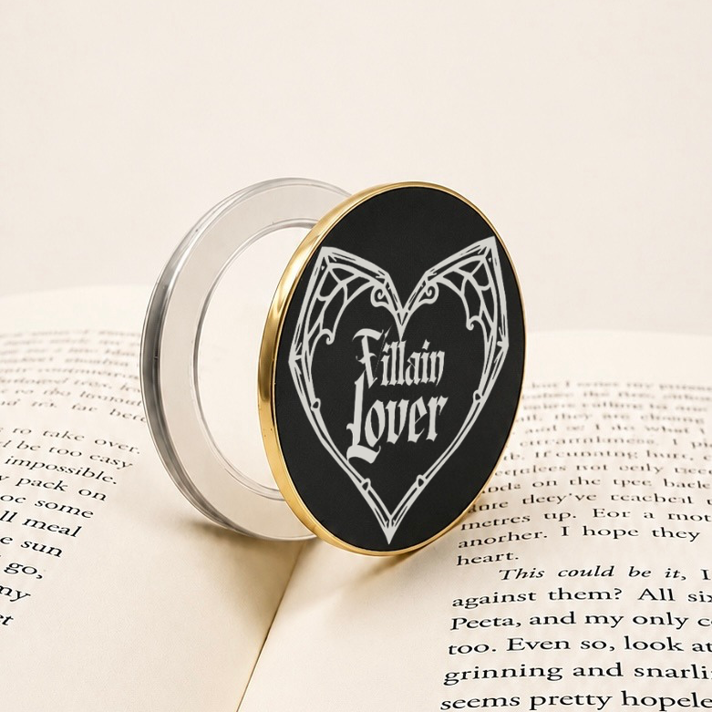     Villain Lover Metal MagSafe Kindle Grip with black and silver gothic design displayed on an open book