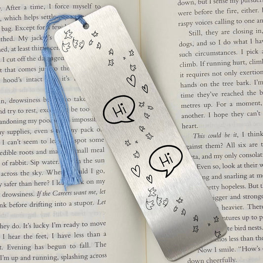     Silver Bookish Gay Romance Metal Bookmark displayed on an open book with engraved romance design