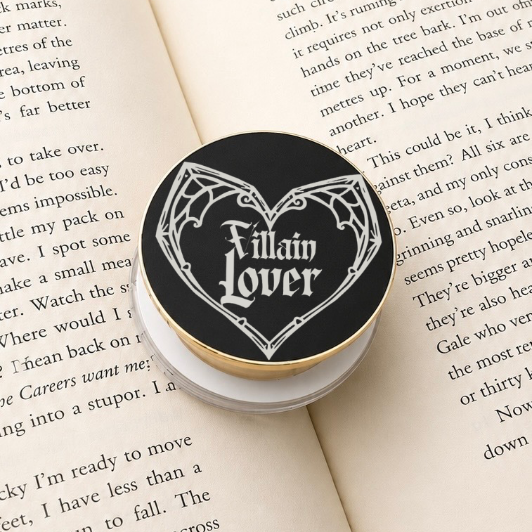Villain Lover Metal MagSafe Kindle Grip featuring gothic lettering displayed on an open book