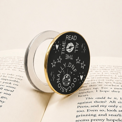     Read All The Time DNF Occasionally Metal MagSafe Kindle Grip with black engraved face, gold trim and clear magnetic base.