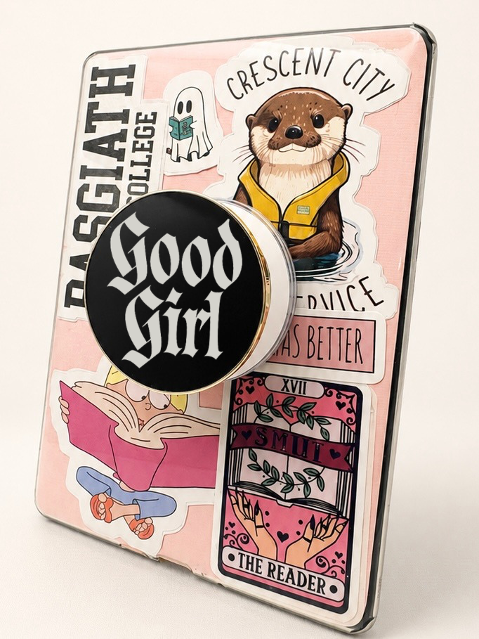     Good Girl Metal MagSafe Kindle Grip attached to a pink sticker-covered Kindle for book lovers