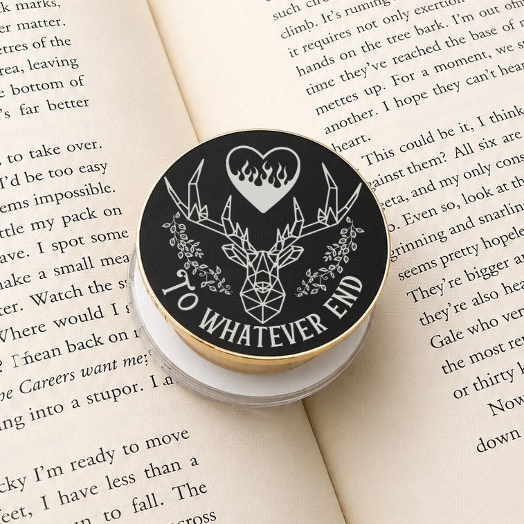 A To Whatever End Metal MagSafe Kindle Grip resting on an open book