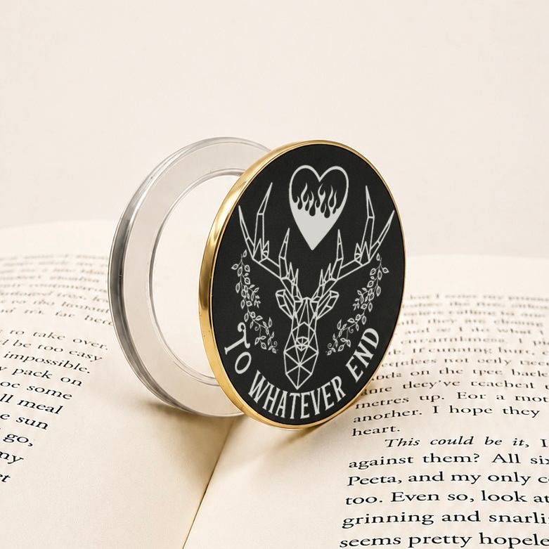 A To Whatever End Metal MagSafe Kindle Grip resting on an open book