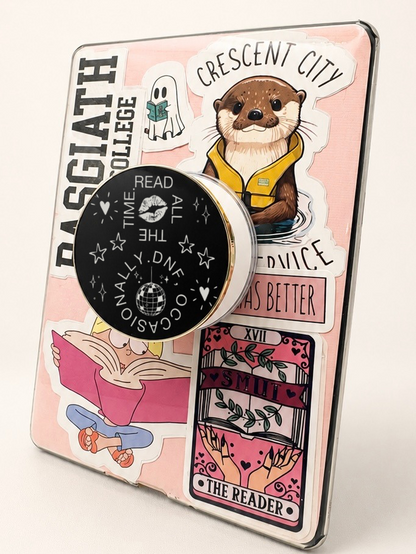     Read All The Time DNF Occasionally Metal MagSafe Kindle Grip attached to a sticker-covered Kindle with pink bookish aesthetic.