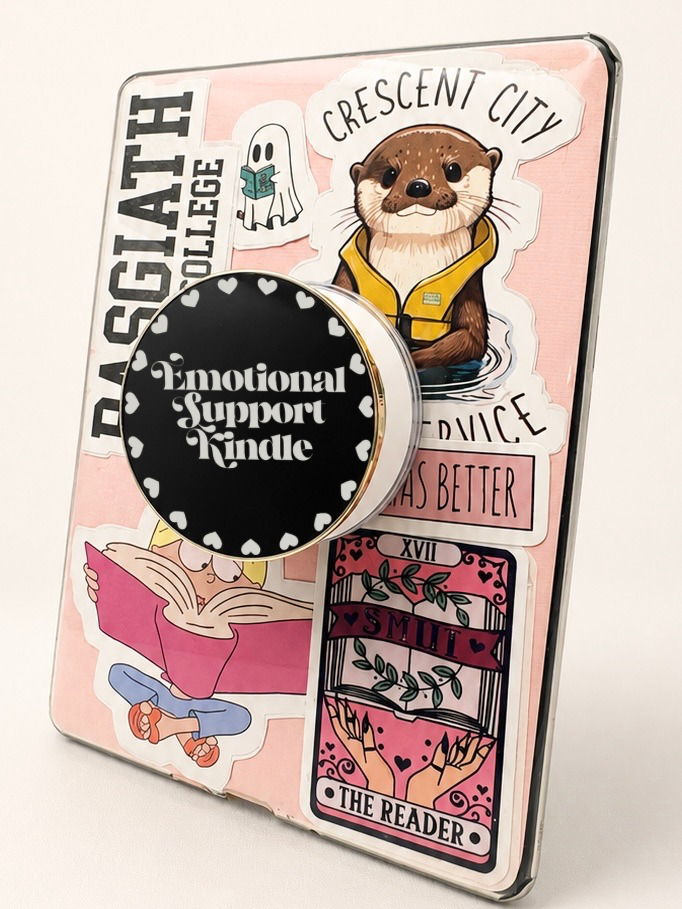 Emotional Support Kindle Metal E-Reader Grip featuring colorful stickers and a metal grip with the quote 'Emotional Support Kindle'.