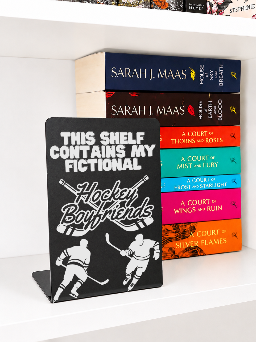     Hockey Boyfriends Metal Bookshelf Sign Bookend displayed beside fantasy and romance book collection