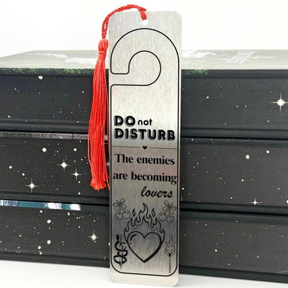     Silver Enemies to Lovers Dark Romance Bookmark displayed on an open book with Do Not Disturb and flaming heart design