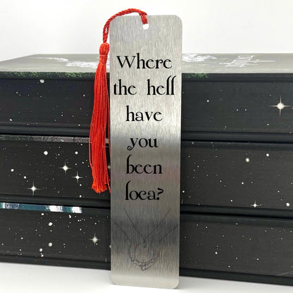     Where Have You Been Loca Metal Bookmark in brushed silver with black quote design and red tassel.