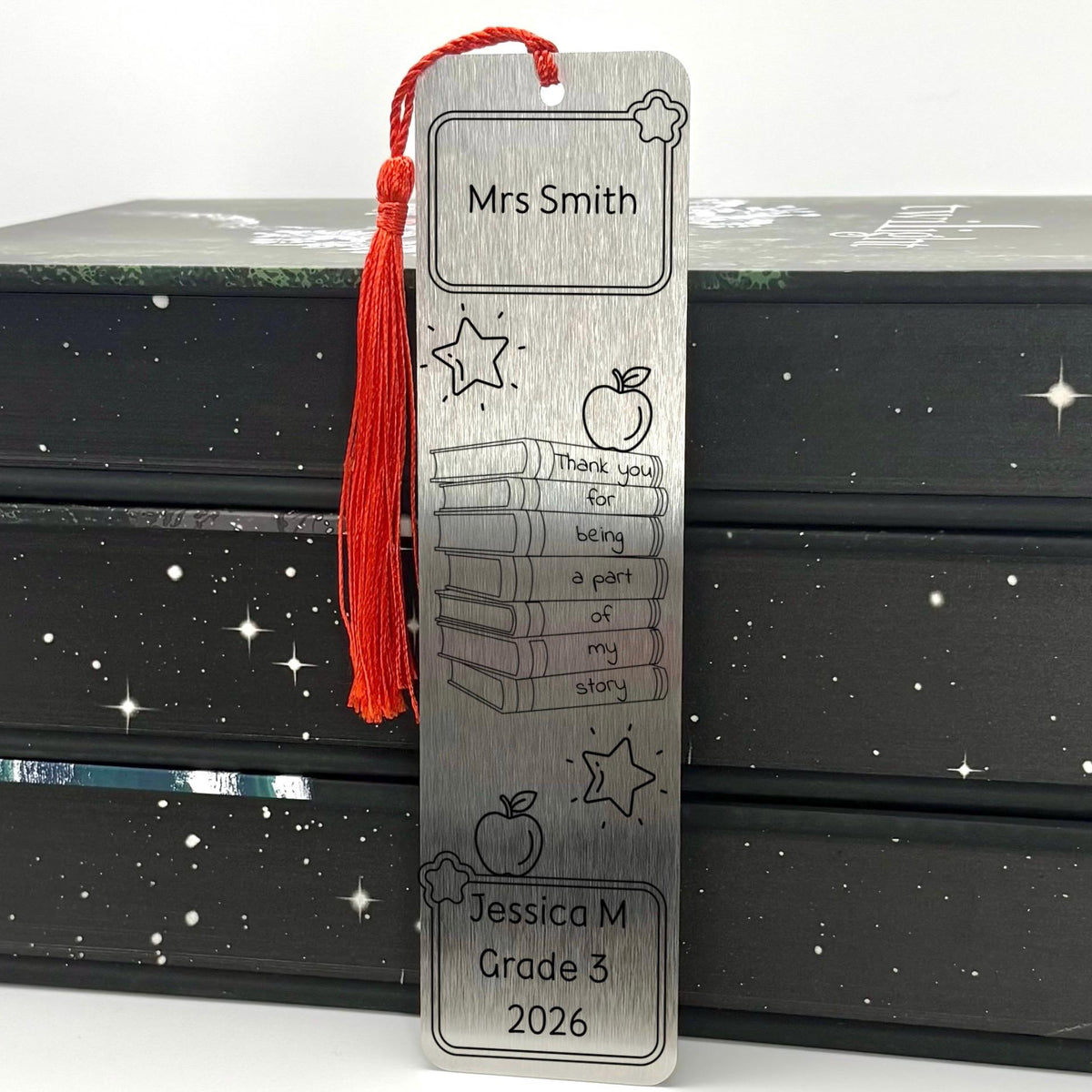     Personalised Teacher Gift Metal Bookmark in brushed silver with engraved teacher name, books, stars and apple design