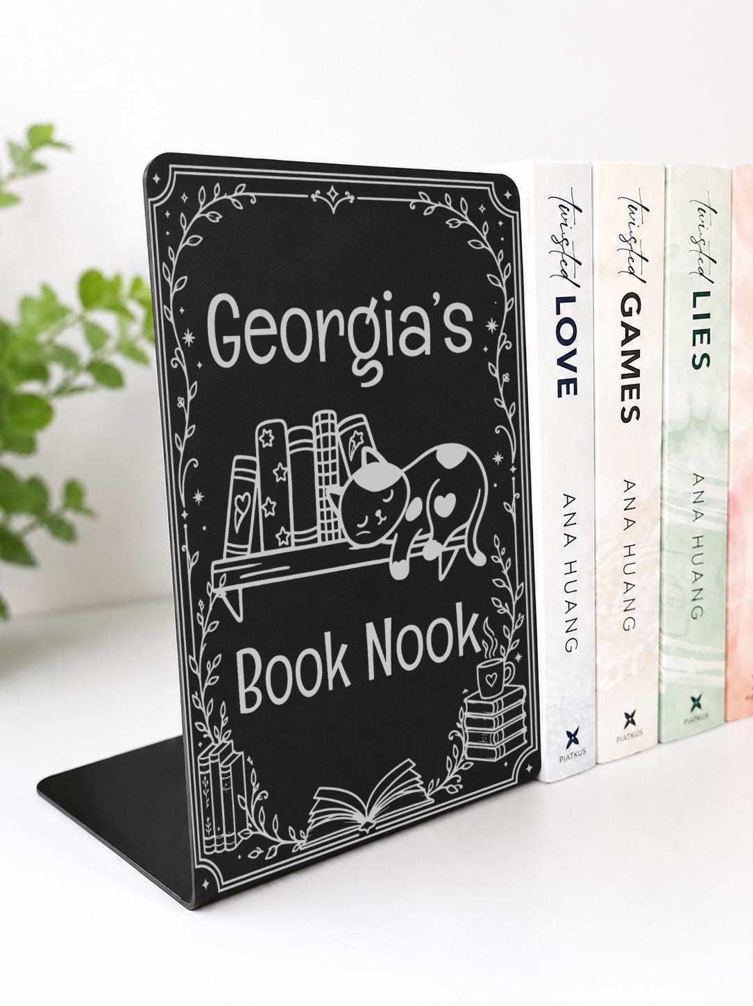     Personalised Name Metal Bookshelf Sign Bookends in black with a custom name, sleeping cat, books and book nook design on a white bookshelf.