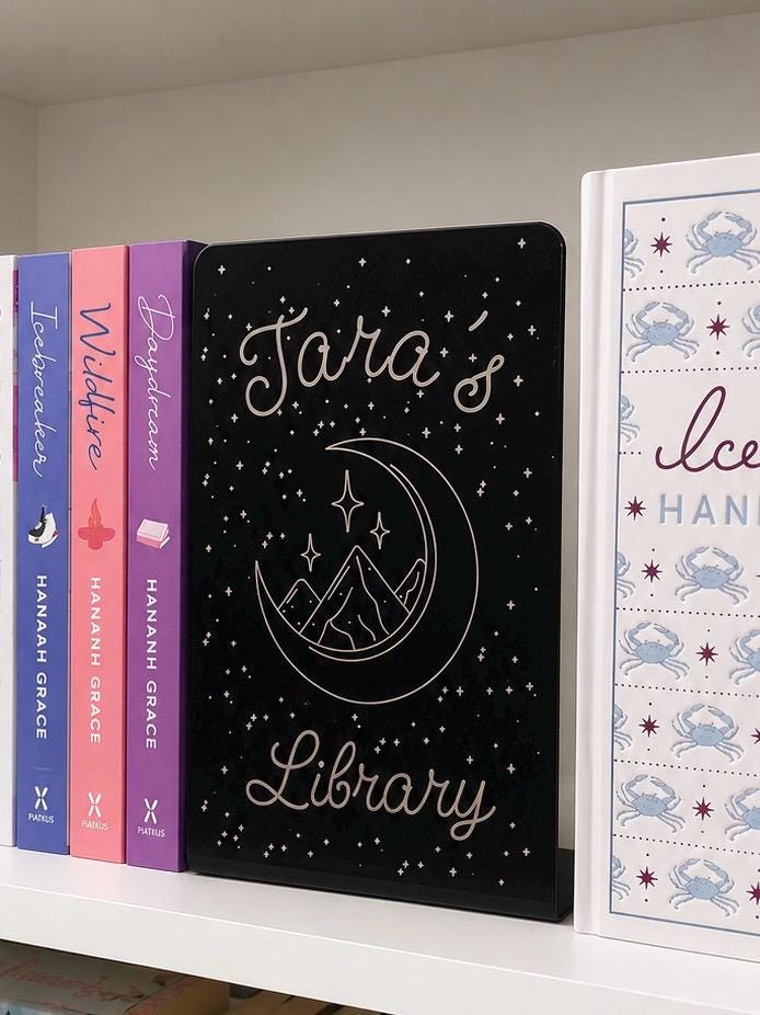     Personalised Name Library Metal Bookshelf Sign Bookends with custom name and celestial design displayed between books