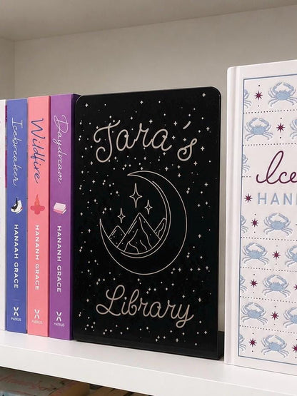     Personalised Name Library Metal Bookshelf Sign Bookends with custom name and celestial design displayed between books