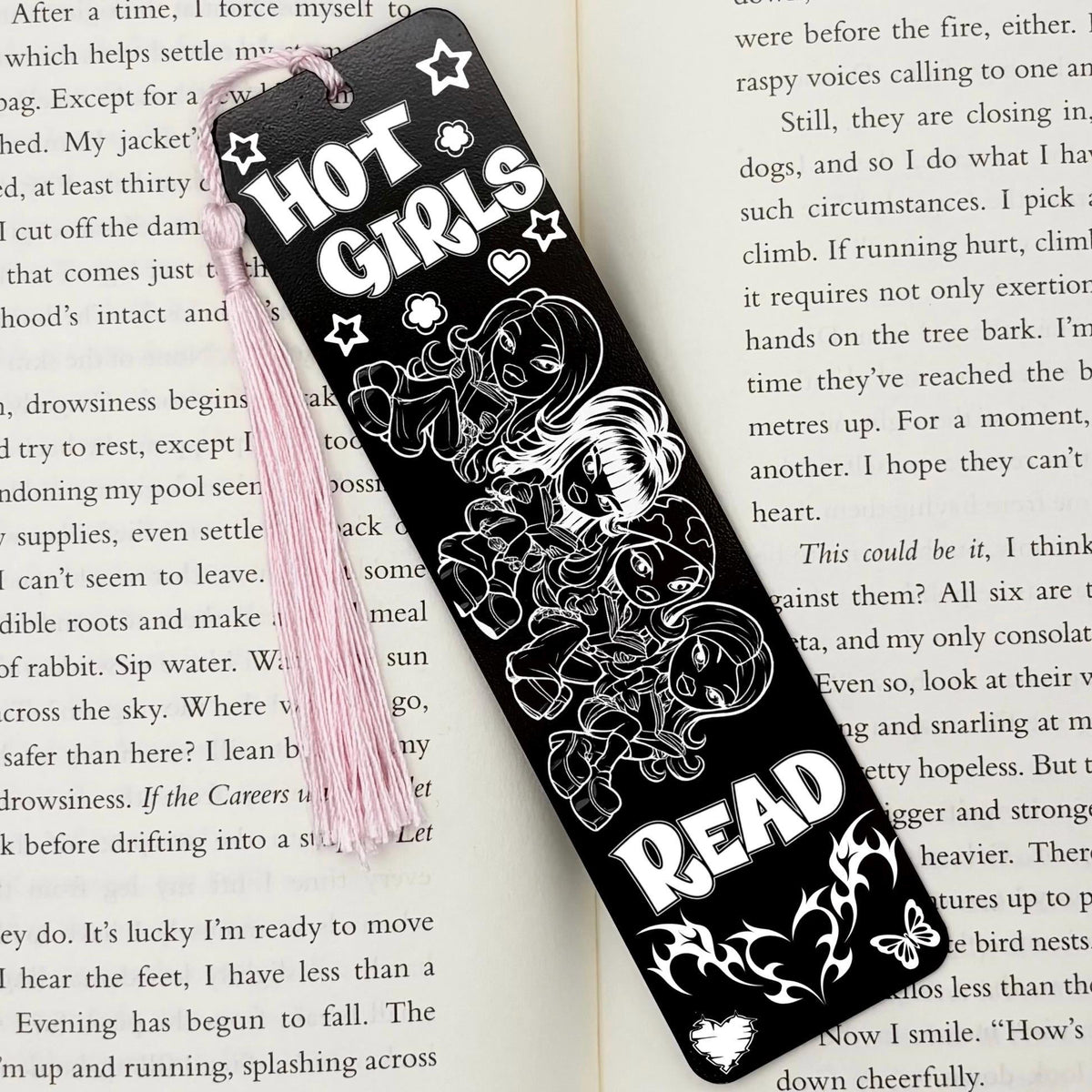 A Y2K Hot Girls Read Metal Bookmark on an open book with a pink tassel