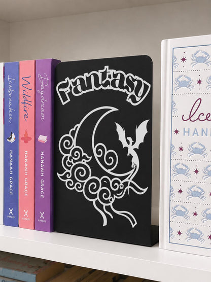     Fantasy Genre Metal Bookshelf Sign Bookend with dragon, moon and cloud design beside colourful romance and fantasy novels
