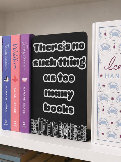     There Is No Such Thing As Too Many Books Metal Bookshelf Sign Bookend featuring an engraved book stack design beside colourful novels.